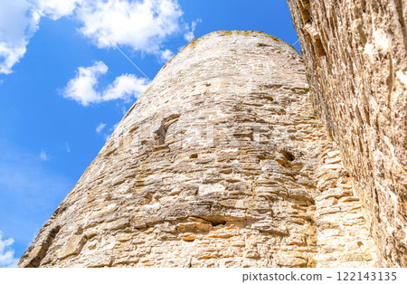 Stone tower of the ancient Izborsk fortress against a blue sky. Izborsk, Pskov region, Russia. Medieval castle on the 14th century 122143135
