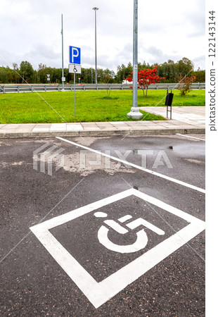 Parking lot with handicapped or disabled signs and marking lines on asphalt at the city 122143144