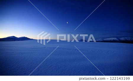 Beautiful snowy field illuminated by a crescent moon 2 122143199