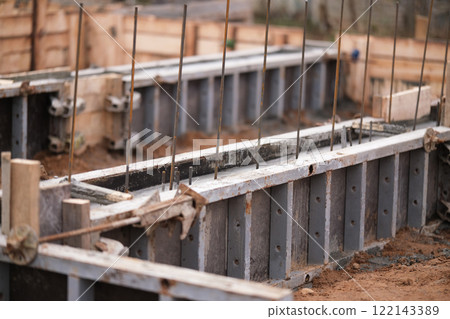Construction of pile-grillage foundation. Monolithic foundation with metal reinforcement. Monolithic concrete foundation. House construction 122143389