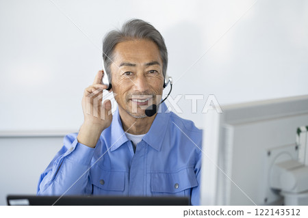 Senior male call center operator image wearing work clothes looking at camera with headset Senior male call center operator image wearing work clothes looking at camera with headset 122143512