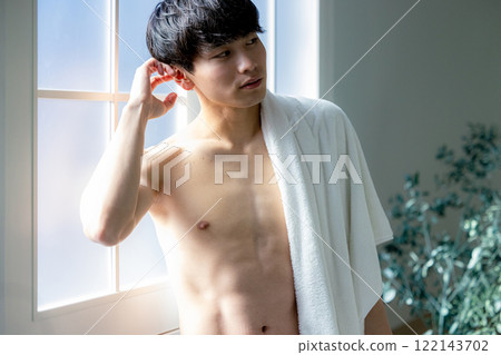 man wiping face with towel man wiping face with towel 122143702