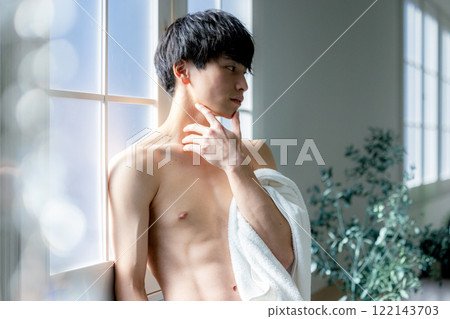 man wiping face with towel 122143703