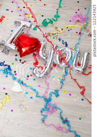 Confetti, streamers and foil balloon I Love You are lying on the floor. 122143925