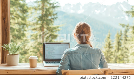 Woman Working on Laptop with Mountain View and Coffee - Remote Work, Nature Inspiration, Digital Nomad Lifestyle 122144275