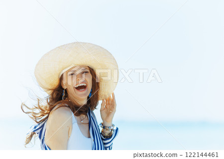 smiling modern 40 years old woman on seashore having fun time smiling modern 40 years old woman on seashore having fun time 122144461
