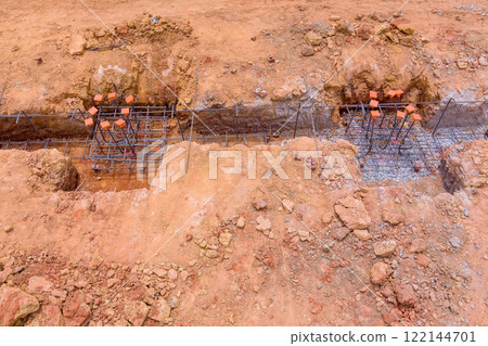 Prepare foundation trenches with rebar frameworks gravel at new construction site Prepare foundation trenches with rebar frameworks gravel at new construction site 122144701