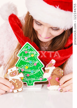 Woman santa claus hat with gingerbread cookies. Christmas 122144755