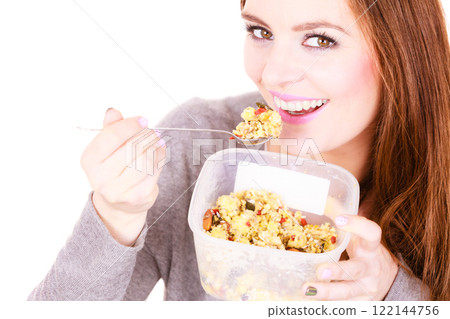 Woman eat oatmeal with dry fruits. Dieting 122144756