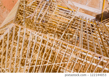 Construction workers collaborate to erect wooden framework new building in construction site Construction workers collaborate to erect wooden framework new building in construction site 122144853