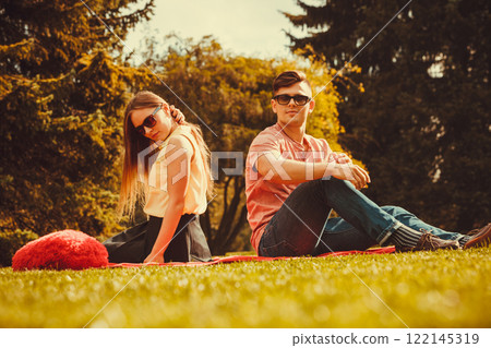 Moody girl with boyfriend in park. 122145319