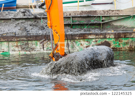 Excavator shovel digging in sand from water Excavator shovel digging in sand from water 122145325