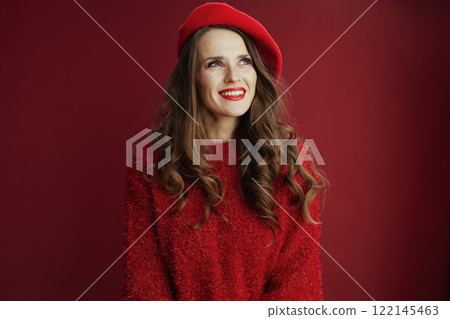 pensive elegant woman in sweater and beret on background 122145463