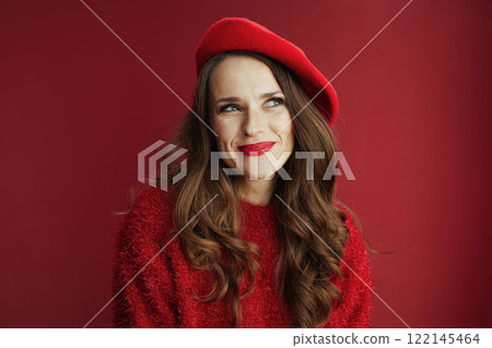 happy woman in sweater and beret against background 122145464