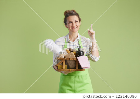 happy woman pointing on copy space isolated on green happy woman pointing on copy space isolated on green 122146386