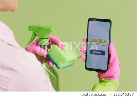 Modern woman using phone on green Modern woman using phone on green 122146397
