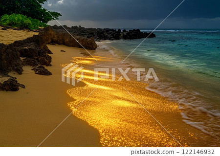 Golden sunlight reflects on gentle waves at a tropical beach during sunset in a serene coastal area 122146932