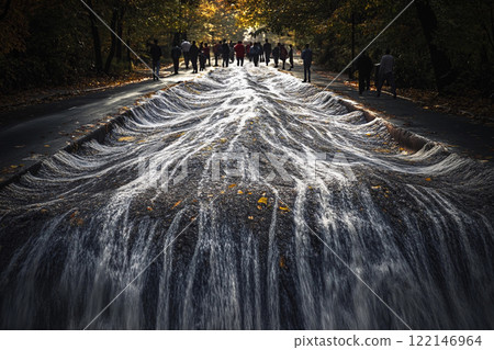 Waterfall cascades through city streets creating a stunning contrast between nature and urban life 122146964