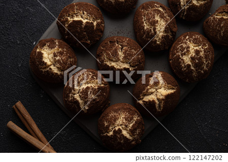 Cinnamon crinkle cookies on a black background flat lay 122147202