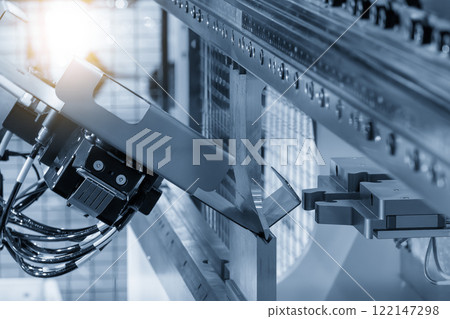 High technology bending machine operation with robotic system in the light blue scene. High technology bending machine operation with robotic system in the light blue scene. 122147298