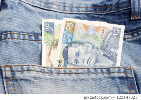 Old Myanmar kyat in the pocket of blue jeans Old Myanmar kyat in the pocket of blue jeans 122147325