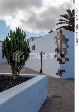 Street with a big cactus and a cross, Teguise, Spain Street with a big cactus and a cross, Teguise, Spain 122147390