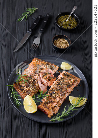 baked salmon fillet with lemon, rosemary on plate 122147523