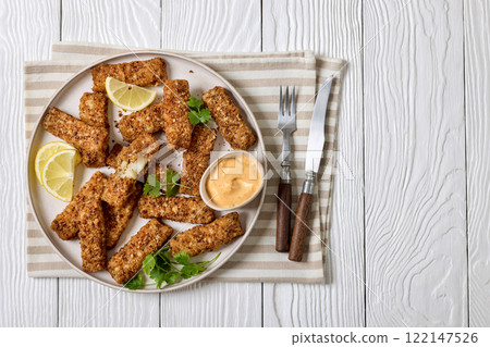 pretzel crusted fish sticks with lemon, mayo sauce 122147526