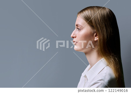Profile view, serious young woman, copy space gray studio background Profile view, serious young woman, copy space gray studio background 122149016