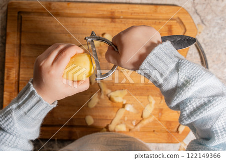 Child Peeling a Potato 122149366