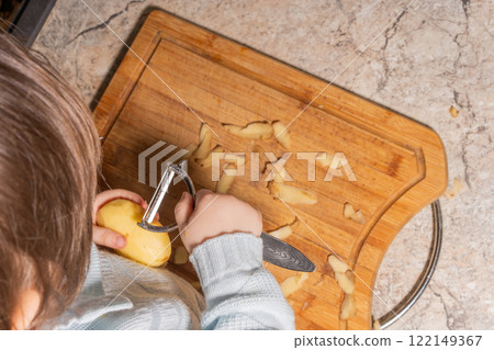Child Peeling a Potato 122149367