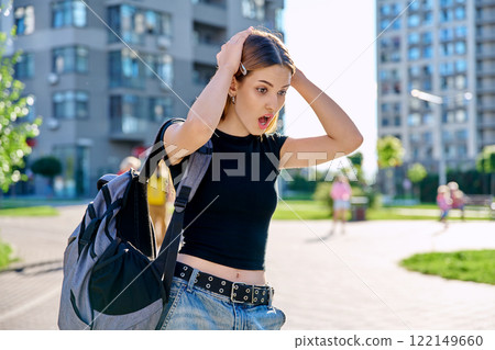 Surprised teenage girl student with backpack outdoor 122149660