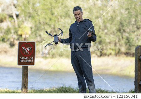 Man is sad that he is not allowed to fly his drone in state park no drone area. Operator is unauthorised to use UAS near restriction sign 122150341