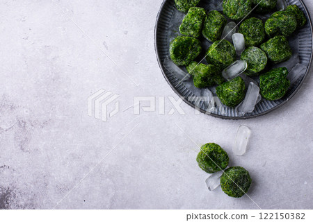 Frozen spinach green cubes in bowl 122150382