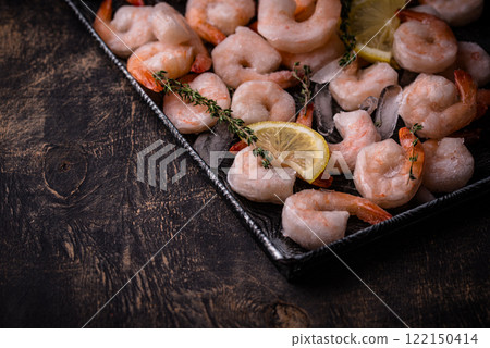 Frozen uncooked prawns or shrimps with lemon Frozen uncooked prawns or shrimps with lemon 122150414
