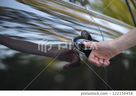 Closeup of driver hand opening car front door with touch ID finger imprint scanning technology. Vehicle safety concept Closeup of driver hand opening car front door with touch ID finger imprint scanning technology. Vehicle safety concept 122150458