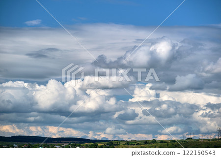 Bright landscape of white puffy cumulus clouds on blue clear sky. Bright landscape of white puffy cumulus clouds on blue clear sky. 122150543