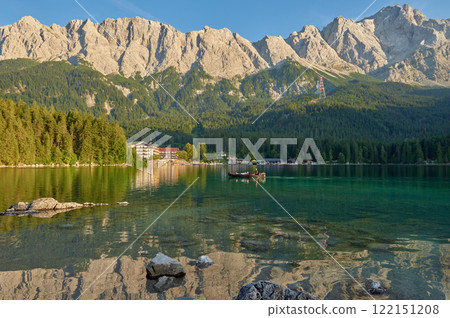 Crystal Clear Eibsee Lake Reflecting Majestic Zugspitze at Golden Sunset: Breathtaking Alpine Landscape Showcases Bavarian Natural Wonder and Outdoor Paradise 122151208