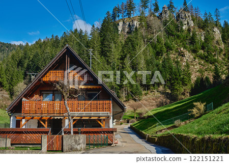 Mountain cottage in the Alps. Panoramic view of beautiful mountain landscape in the Bad Rippoldsau-Schapbach in the Black Forest, area near Burgbach Wasserfall, Baden-Wurttemberg, southern Germany. Mountain cottage in the Alps. Panoramic view of beautiful mountain landscape in the Bad Rippoldsau-Schapbach in the Black Forest, area near Burgbach Wasserfall, Baden-Wurttemberg, southern Germany. 122151221