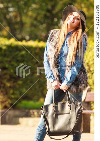 Fashionable model posing in park 122151909