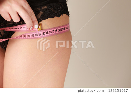 Woman measuring her hips closeup 122151917