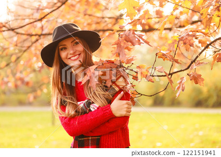 Woman standing by the tree. Woman standing by the tree. 122151941
