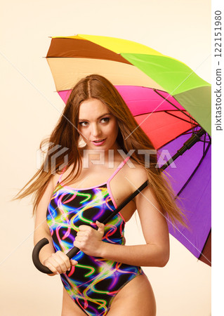 Happy woman posing in swimsuit and colorful umbrella 122151980