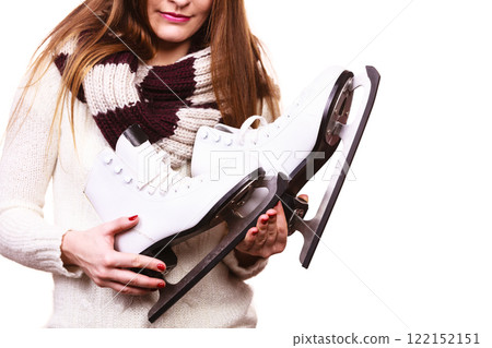 Smiling woman with ice skates Smiling woman with ice skates 122152151