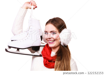 Woman with earmuffs and ice skates. Woman with earmuffs and ice skates. 122152153