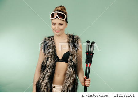 Sexy woman holding ski poles 122152161