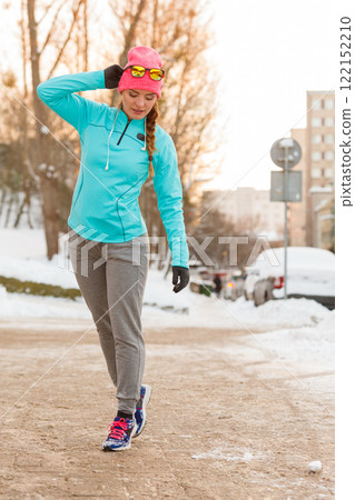 Girl taking morning walk in winter Girl taking morning walk in winter 122152210