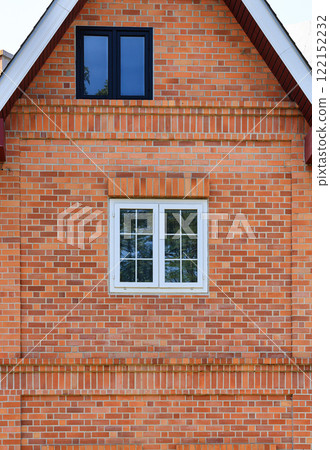 Building made of brick facade with beautiful white wooden windows. Building made of brick facade with beautiful white wooden windows. 122152232