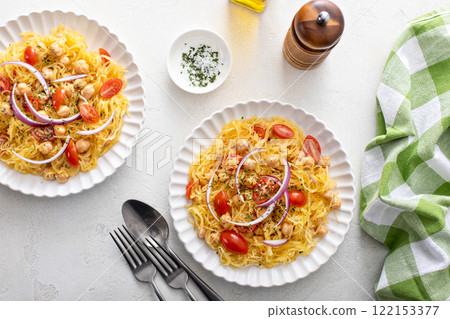 Spaghetti squash with chickpeas and tomatoes topped with red onion, low carb vegan recipe idea Spaghetti squash with chickpeas and tomatoes topped with red onion, low carb vegan recipe idea 122153377