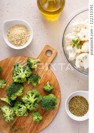 Bowl of cauliflower with broccoli, ready to be roasted, cooking with vegetables Bowl of cauliflower with broccoli, ready to be roasted, cooking with vegetables 122153391